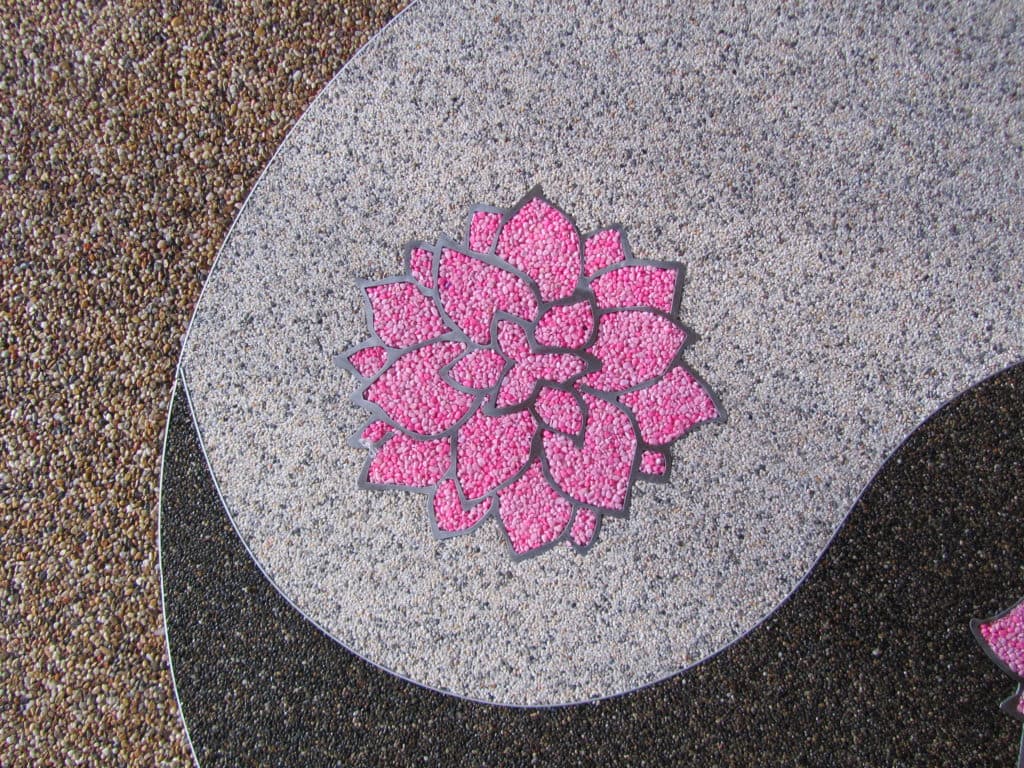 Custom yin yang pattern inlaid in terrazzo flooring with contrasting aggregate colours