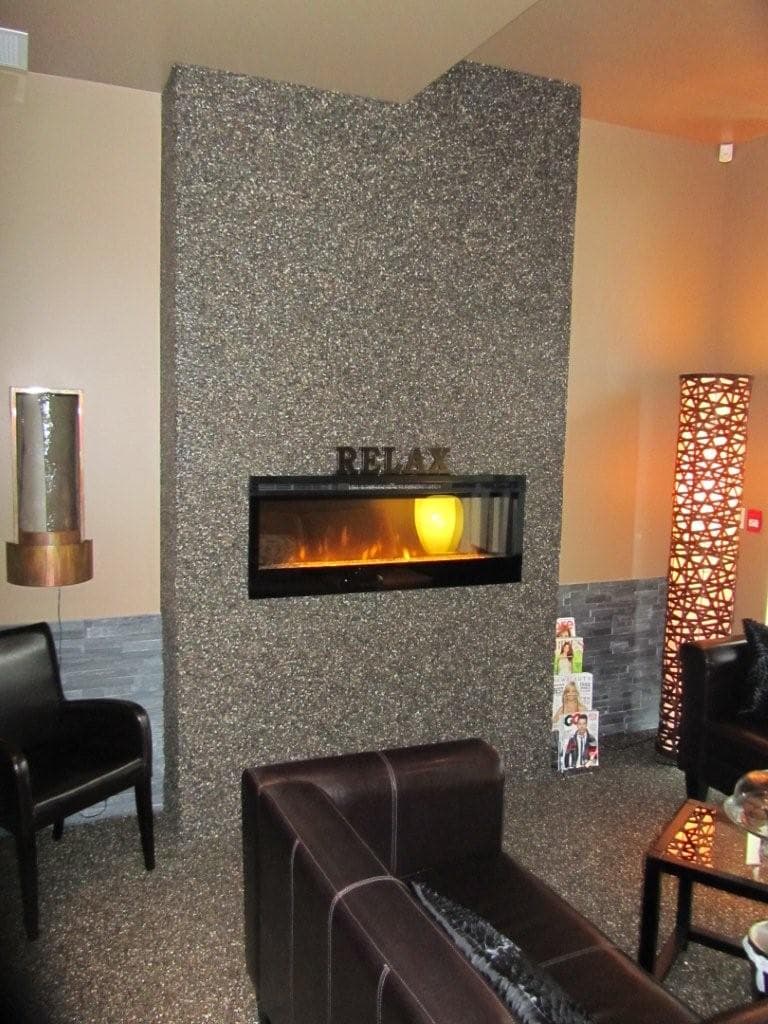 Custom terrazzo fireplace surround inside a White Rock spa